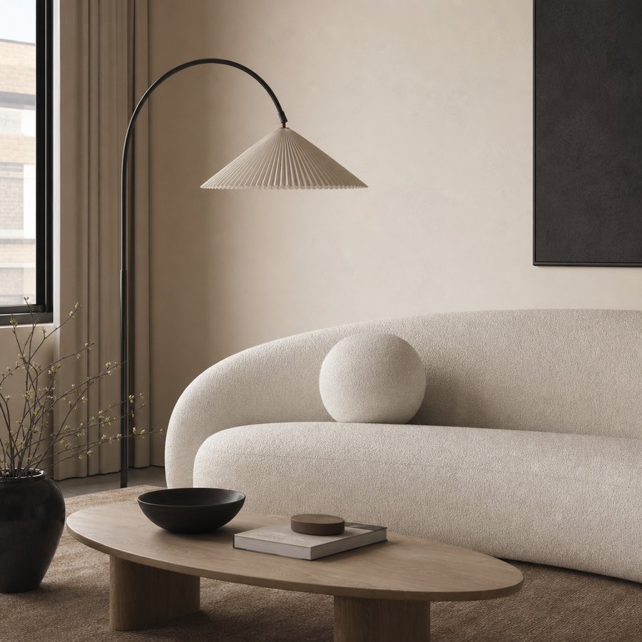 Living room corner with bouclé sofa and arched lamp